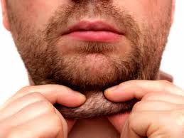 Close up of a bearded man pinching the soft tissue under his chin