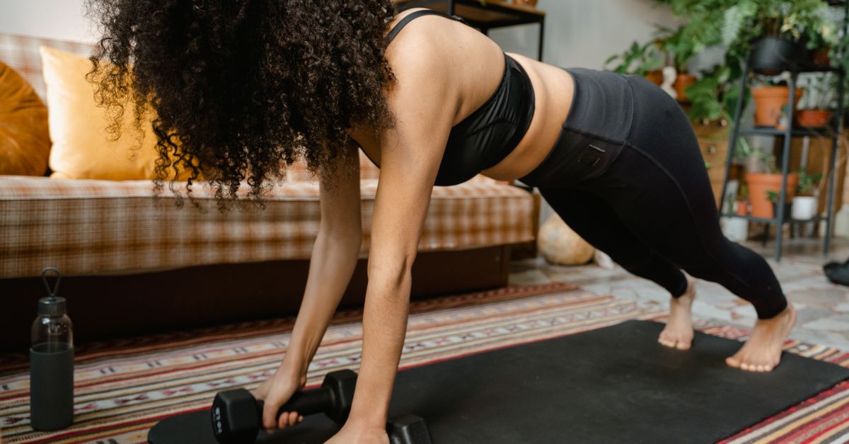 Woman performing a plank exercise in a gym