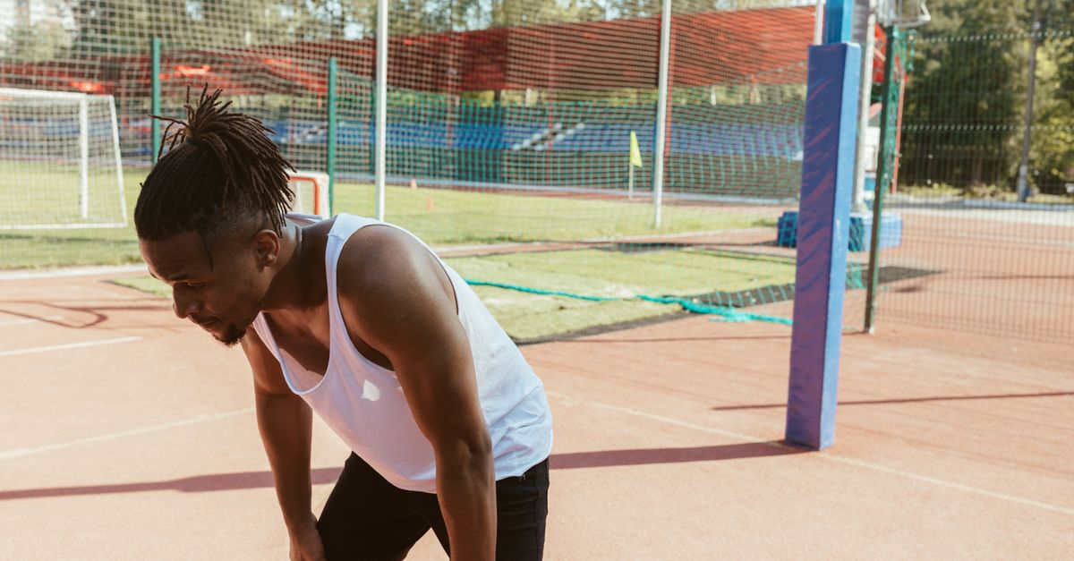 Athlete catching their breath after a training session, the recovery window in which protein is used for muscle growth