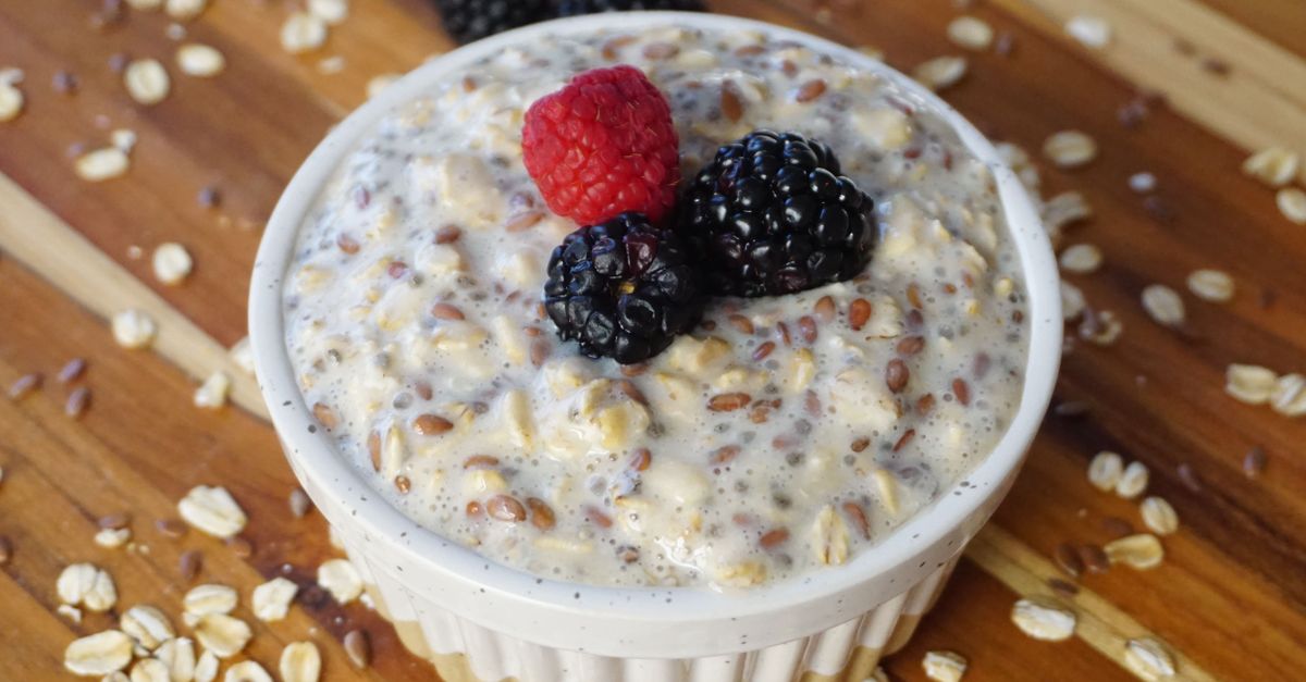 Bowl of oats topped with raspberries and blackberries, a breakfast weighed for calories deficit meals