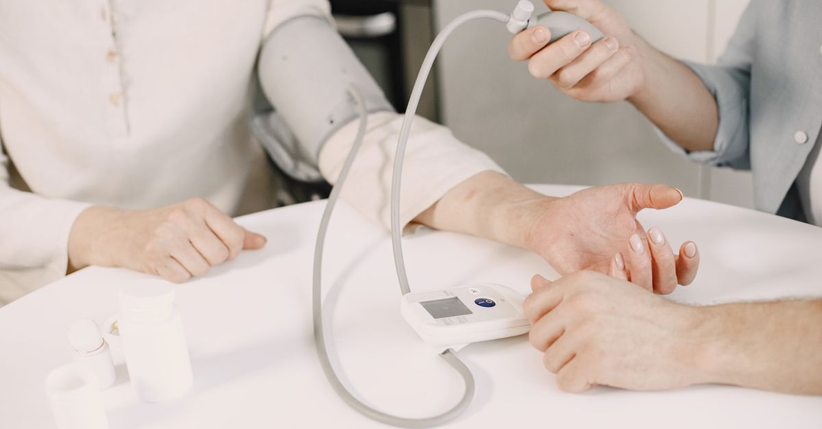 A blood pressure reading being taken with an upper arm cuff