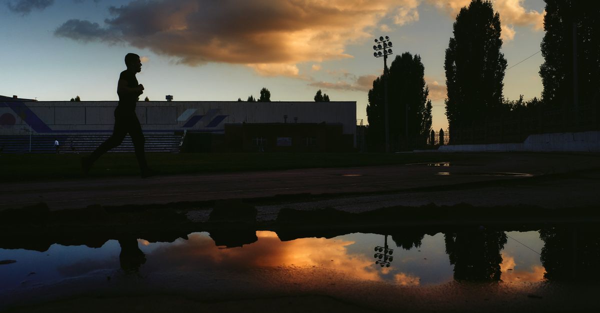 A runner silhouetted against the sky just after sunset, one of the cooler windows in summer