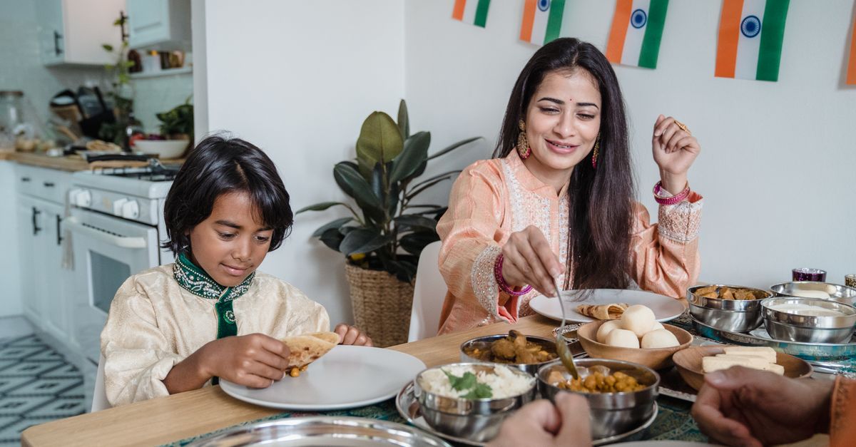 Indian mother and son sharing a home cooked meal at the table, the family wide habit that helps