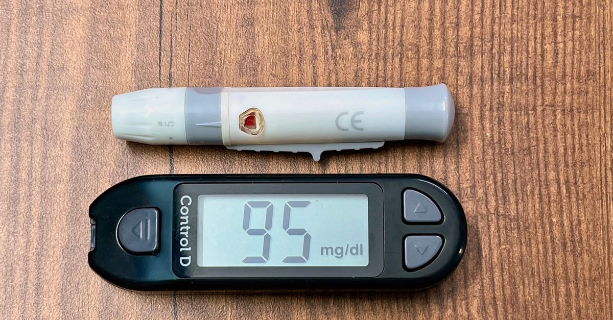 A blood glucose meter and lancing device on a wooden table, the measure cinnamon trials actually tracked