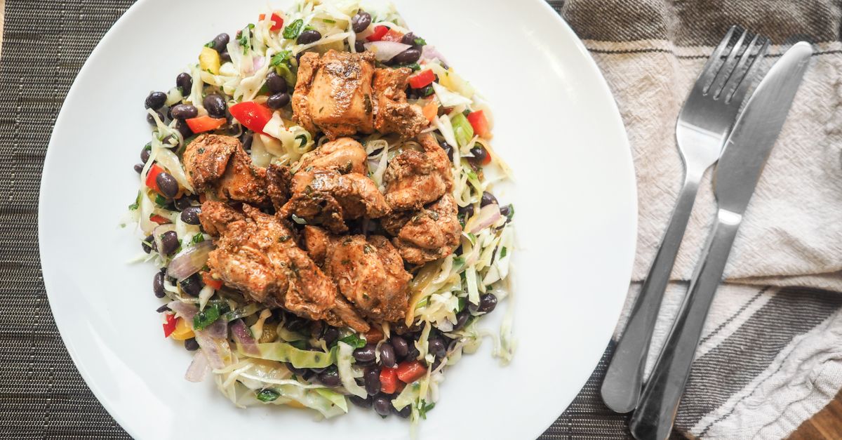 Plate of chicken, black beans and cabbage, a protein rich meal while trying to lose fat and gain muscle