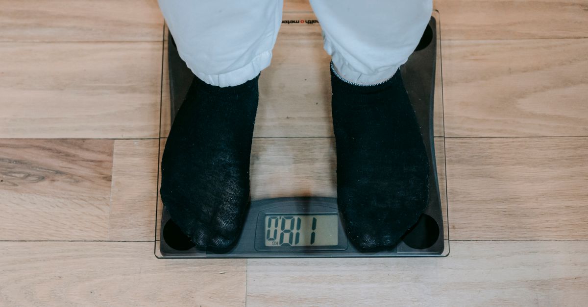 Person in socks standing on a digital bathroom scale