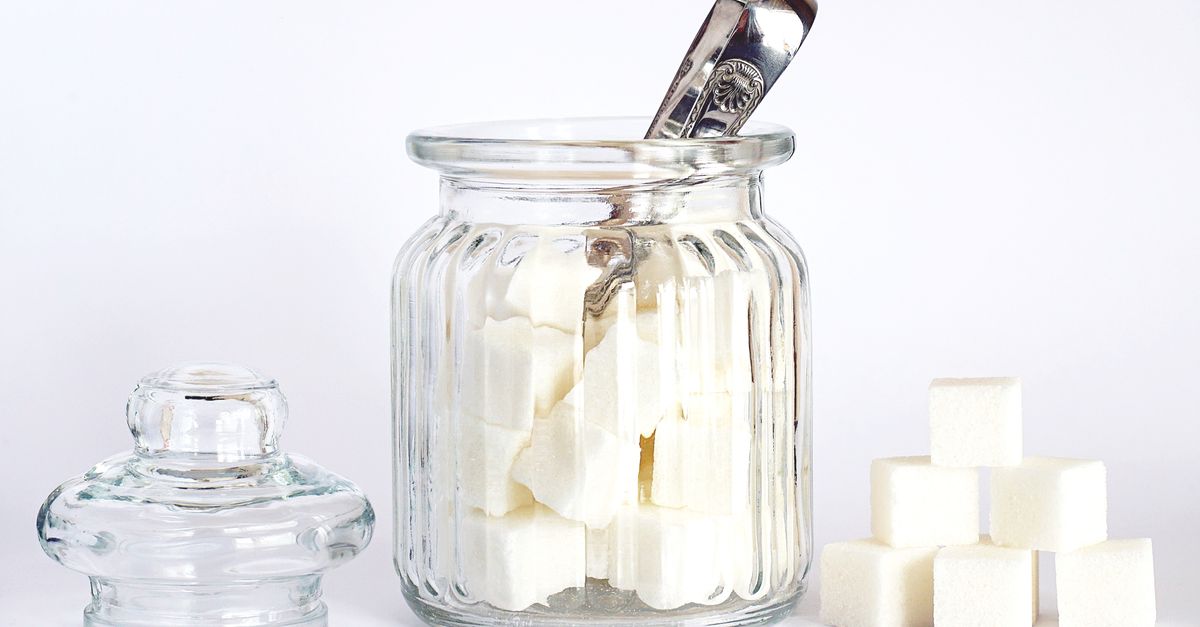 Glass jar of white sugar cubes, the food cancer diet myths tell people to cut out