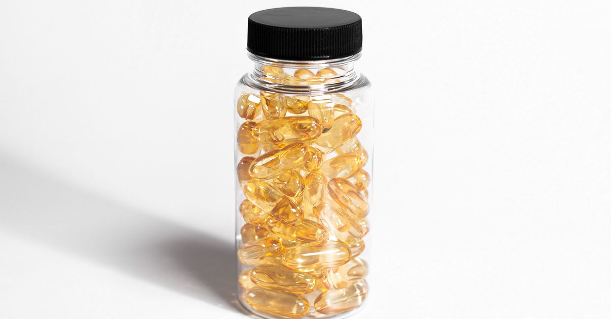 Clear bottle packed with yellow softgel capsules, the vitamin D supplement tested in weight loss trials